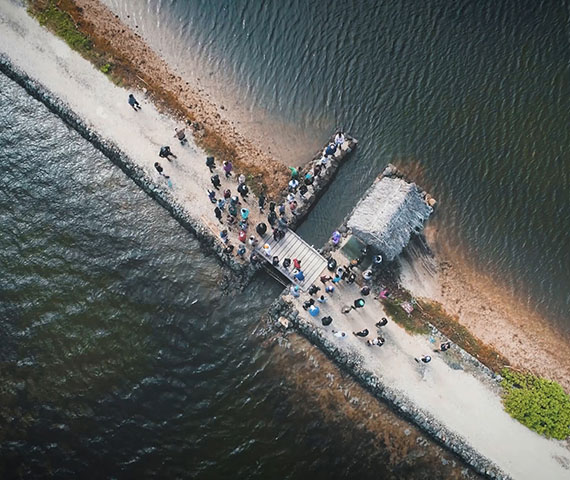 Why Innovation in Hawaii? sill of an aerial view of a hale with students on a wall at a Native Hawaiian loʻi - taken from a documentary film produced by Hyperspective