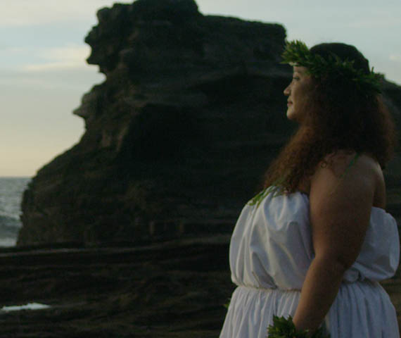 Sunrise - still of a woman wearing traditional Hawaiian clothing standing in a Hawaiian landscape at sunrise taken from a film produced by Hyperspective