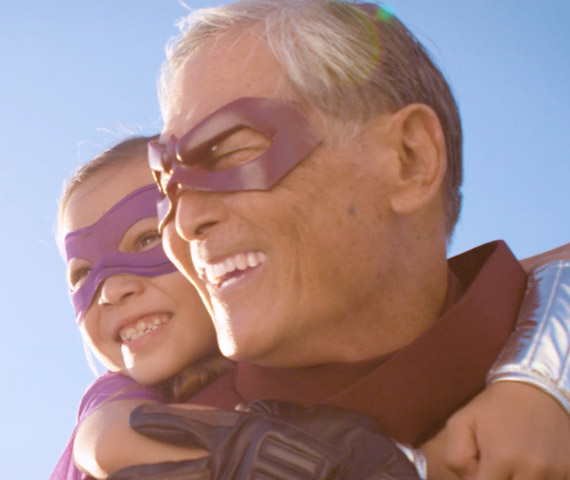 Hero - still or a young girl and her grandpa wearing super hero costumes taken from a campaign created, filmed, and produced by Hyperspective